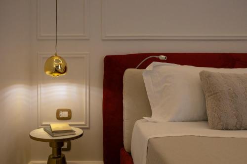 a bedroom with a bed and a table with a lamp at Villa Libertà in Palermo