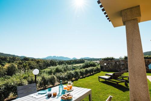 a white table with food on top of a garden at Le Ville Le Saline in Palau