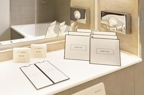 a counter with boxes on it in front of a mirror at Hotel Hamburger Hof in Frankfurt/Main