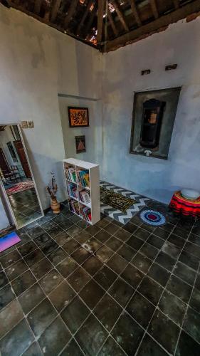 a room with a tiled floor and a room with a counter at Rumah Gaharu - Kulon 