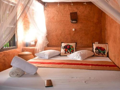 a bedroom with two beds in a room at Mati Gedara Resort in Digana