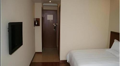 Ένα ή περισσότερα κρεβάτια σε δωμάτιο στο GreenTree Inn Nantong Haian Kaifa District Express Hotel