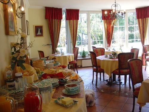 a dining room with a table with dishes on it at Haus am Moos in Salzburg