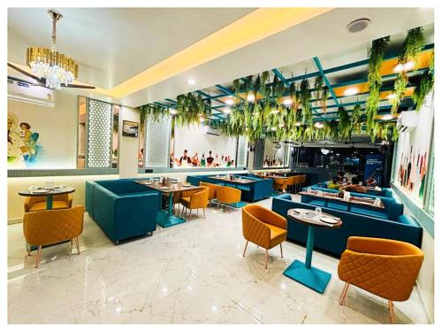 a restaurant with tables and chairs and plants in it at Hotel Moresta Restaurant and Bar Best Facility in Ajmer