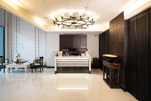 a living room with a chandelier and a table at De Chai Oriental Nimman - SHA Plus in Chiang Mai