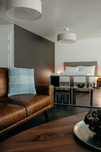a living room with a couch and a bed at Hotel Schloss Hünigen in Konolfingen