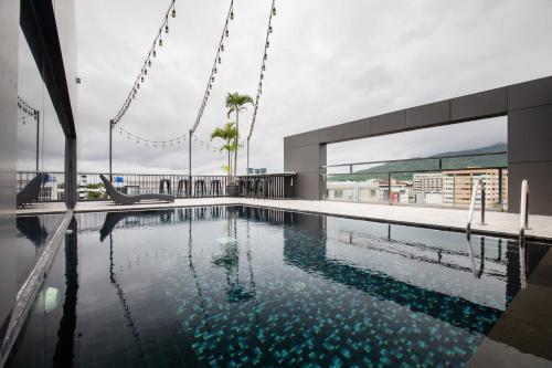 a swimming pool on the roof of a building at De Chai Oriental Nimman - SHA Plus in Chiang Mai