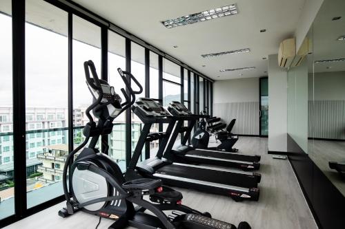a gym with treadmills and ellipticals in a building at De Chai Oriental Nimman - SHA Plus in Chiang Mai