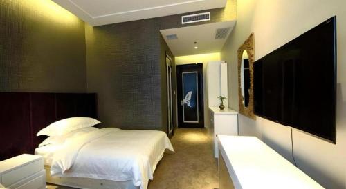 Ένα ή περισσότερα κρεβάτια σε δωμάτιο στο Harbin Ju Jian Hotel
