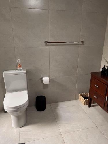 a bathroom with a toilet and a shower stall at Seven in Secunda