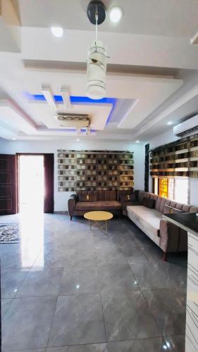 a living room with a couch and a table at Villa piscine midoun djerba in Triffa
