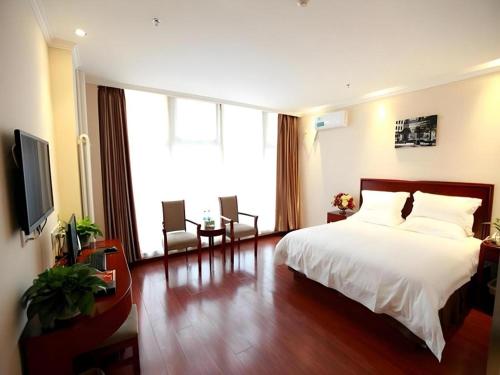 a hotel room with a bed and a large window at GreenTree Inn Beijing Miyun Changcheng Huandao Express Hotel in Nanmujiayu