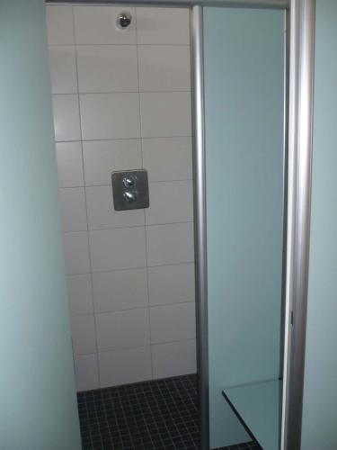 a shower with a glass door in a bathroom at Campingplatz Aichelberg in Aichelberg