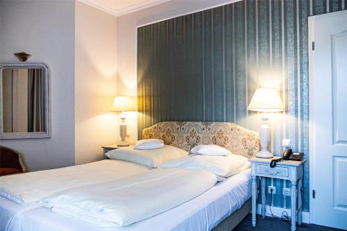 a hotel room with a bed with two pillows at Seehotel Frankenhorst - BW Signature Collection in Schwerin