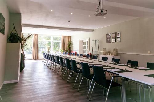 a large room with a long table and chairs at Seehotel Frankenhorst - BW Signature Collection in Schwerin