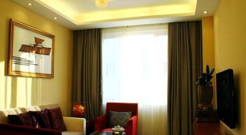 a living room with a window and a couch and a tv at Xiamen Airlines Quanzhou Hotel in Quanzhou