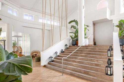 a staircase in a building with potted plants at Wyndham Palmas Beach and Golf Boutique Resort in Humacao