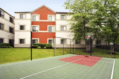 a tennis court in front of a building at Hyatt House Morristown in Morristown
