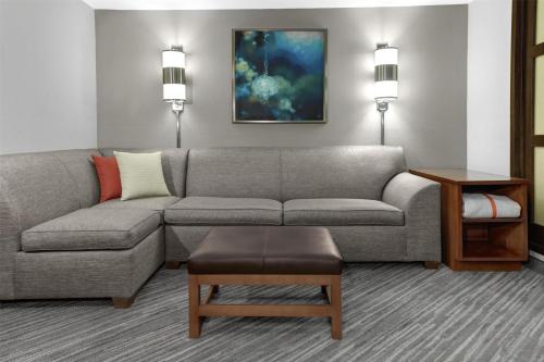 a living room with a couch and a table at Hyatt Place Detroit/Auburn Hills in Auburn Hills