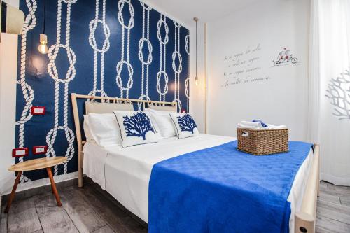 a bedroom with a bed with a blue and white table at Coral Rooms in Torre del Greco