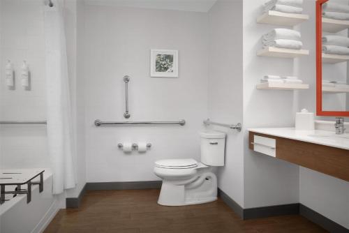 a white bathroom with a toilet and a sink at Hampton Inn and Suites by Hilton Vero Beach-Downtown in Vero Beach