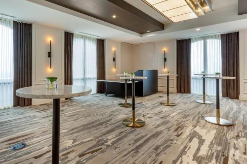 a lobby with two tables and a waiting room at Cambria Hotel Houston Downtown Convention Center in Houston