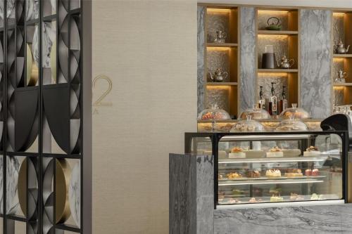 a bakery with a display case with food in it at Signia by Hilton in Amman
