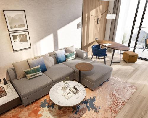 a living room with a couch and a table at Hyatt Place Ha Long Bay, Bai Chay in Ha Long