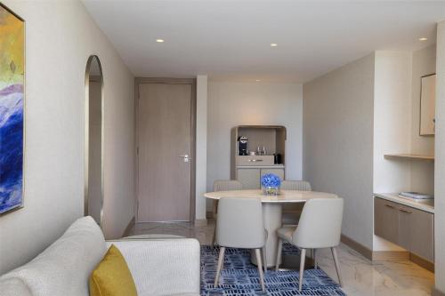 a kitchen and dining room with a table and chairs at Signia by Hilton in Amman