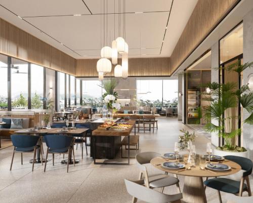 a restaurant with tables and chairs and windows at Hyatt Place Ha Long Bay, Bai Chay in Ha Long