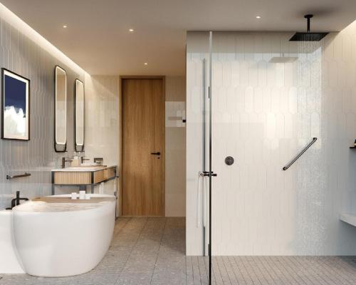 a bathroom with a white tub and a sink at Hyatt Place Ha Long Bay, Bai Chay in Ha Long