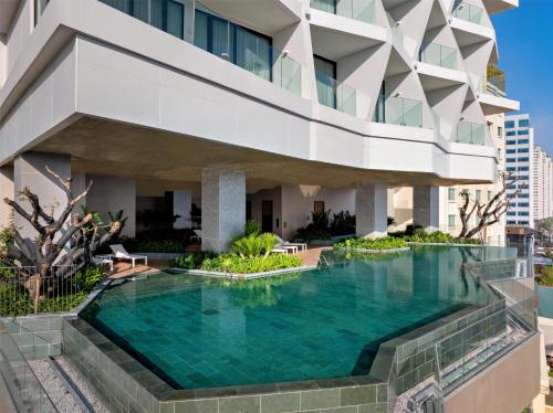 a swimming pool in front of a building at Hyatt Place Ha Long Bay, Bai Chay in Ha Long