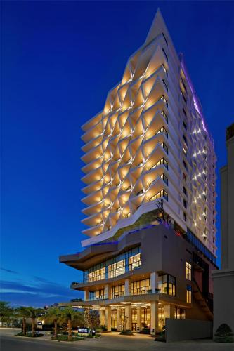 a tall building with lights on it at night at Hyatt Place Ha Long Bay, Bai Chay in Ha Long