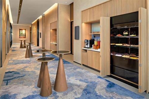 a lobby with two tables and aasteryasteryasteryasteryasteryasteryasteryasteryastery at Hyatt Place Ha Long Bay, Bai Chay in Ha Long
