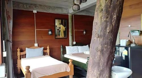 Postel nebo postele na pokoji v ubytování P&P Coffee & Resort Maesariang