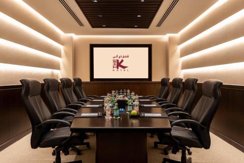 a conference room with a long table and leather chairs at The K Hotel in Manama