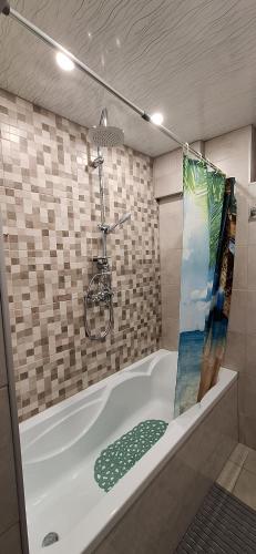 a bathroom with a bath tub with a bicycle on the wall at Stoykite view in Stoykite