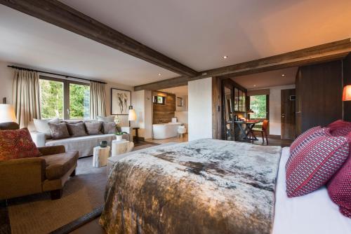 a bedroom with a large bed and a couch at The Lodge in Verbier