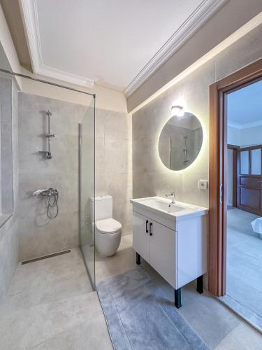 a bathroom with a toilet and a sink and a mirror at Urla Villa in Urla