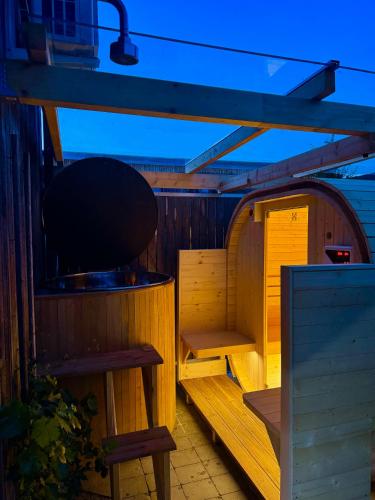 an outside sauna with a bench and a table at Ferienwohnung Rheintal in Feldkirch