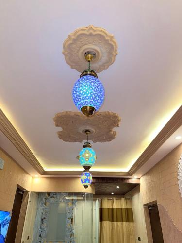 a blue chandelier is hanging from a ceiling at Satoria Villa in Jaipur