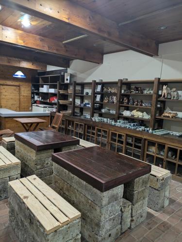 a room with tables and shelves in a store at Men only B&B KegonFalls in Nikko