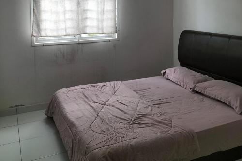 a bed in a room with a window at Iris 32 3BR Corner Lot Wi-fi Mutiara Rini Skudai JB Malay Only in Johor Bahru