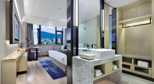 a bathroom with a sink and a room with a bed at Echarm Hotel Guilin North High Speed Railway Station in Guilin