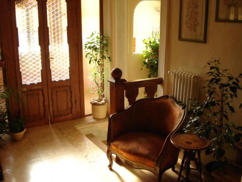 a living room with a chair and an open door at Locanda Modigliani in Ferrara