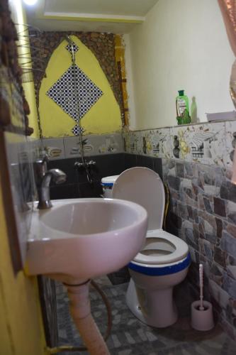 a bathroom with a sink and a toilet at Dar Mayssa Rose in Zawyat