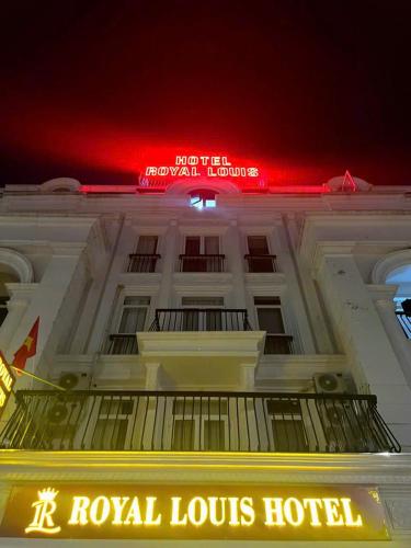 a royal louis hotel with a red neon sign at Royal Louis Hotel in Dai Mo