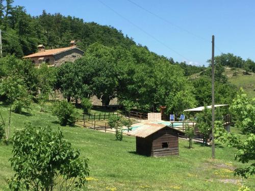 a small house in the middle of a field at Farmhouse in Apecchio with Swimming Pool, Terrace, Garden in Apecchio