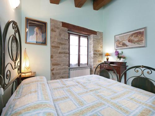 a bedroom with a bed and a window at Farmhouse in Apecchio with Swimming Pool, Terrace, Garden in Apecchio