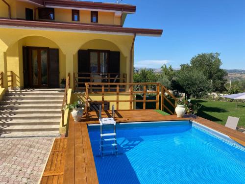 a villa with a swimming pool in front of a house at Relais Green Paradise in Apice